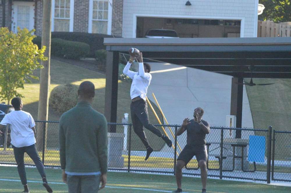 Athlete leaping to catch a football
